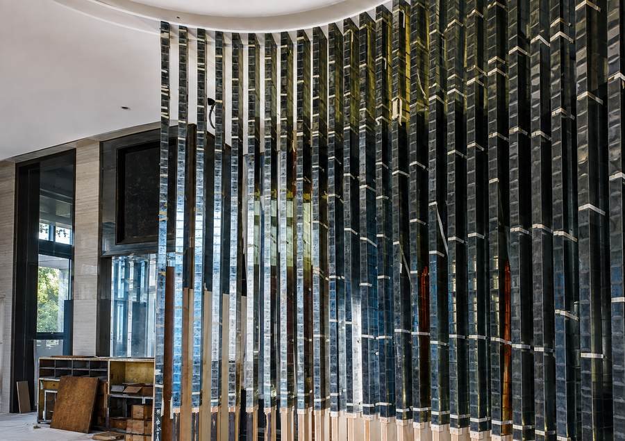 Curved wall of gilded glass fins in gold leaf, St. Regis Kuala Lumpur